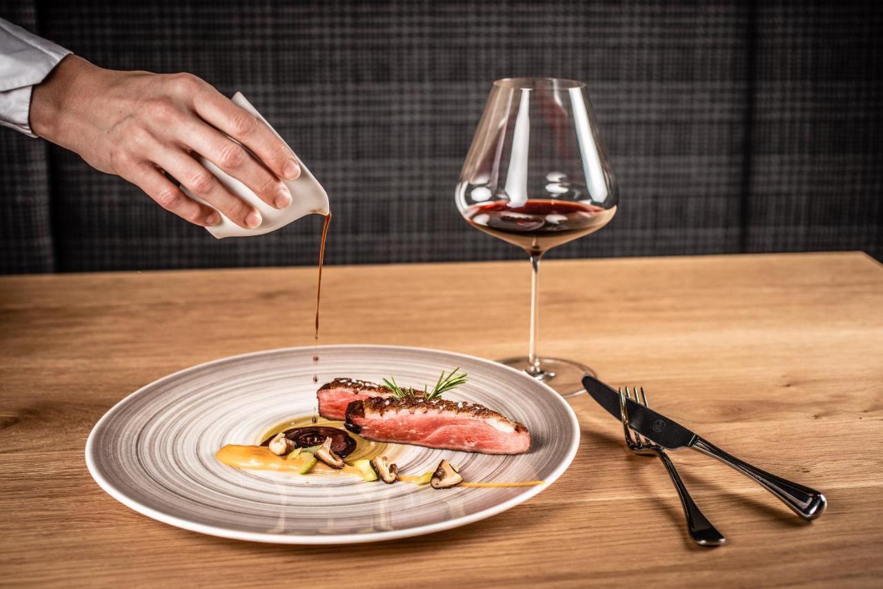 My Arbor - Dolomites Bressanone Exterior foto A server pouring sauce onto a prepared dish